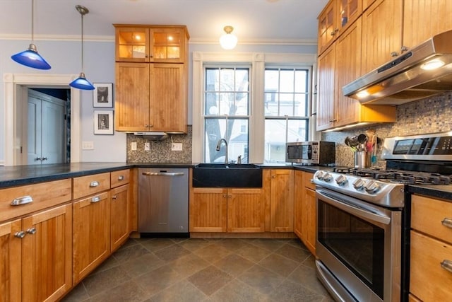 kitchen with pendant lighting, decorative backsplash, sink, stainless steel appliances, and ornamental molding