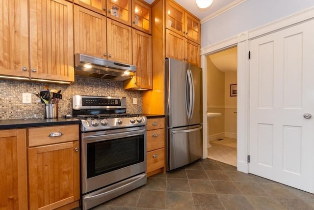 kitchen featuring crown molding, stainless steel appliances, decorative backsplash, and dark tile patterned floors