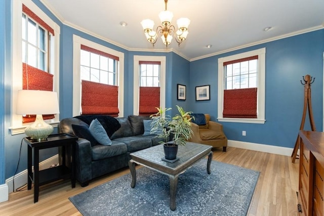 living room featuring wood-type flooring, ornamental molding, and an inviting chandelier