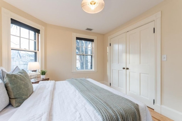 bedroom featuring a closet and light hardwood / wood-style floors