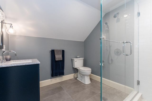 bathroom with lofted ceiling, tile patterned floors, vanity, toilet, and walk in shower