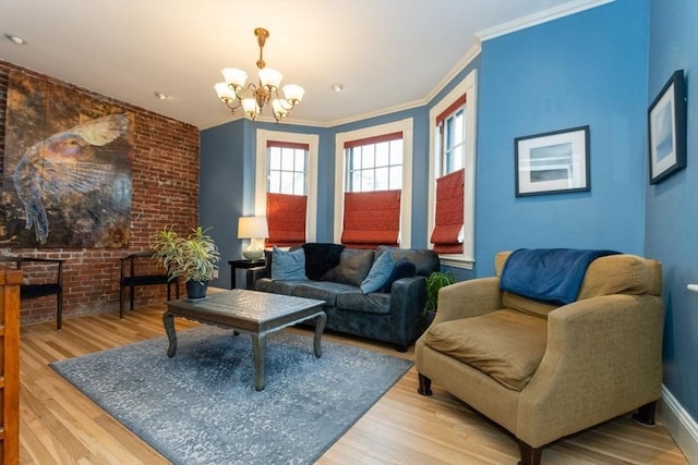 living room with an inviting chandelier, crown molding, and light hardwood / wood-style flooring