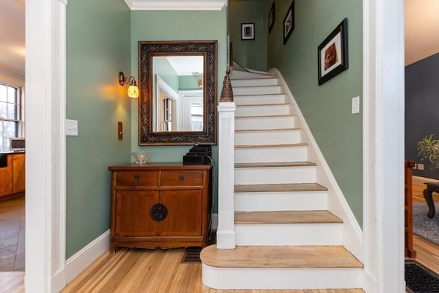 stairway featuring hardwood / wood-style flooring and ornamental molding