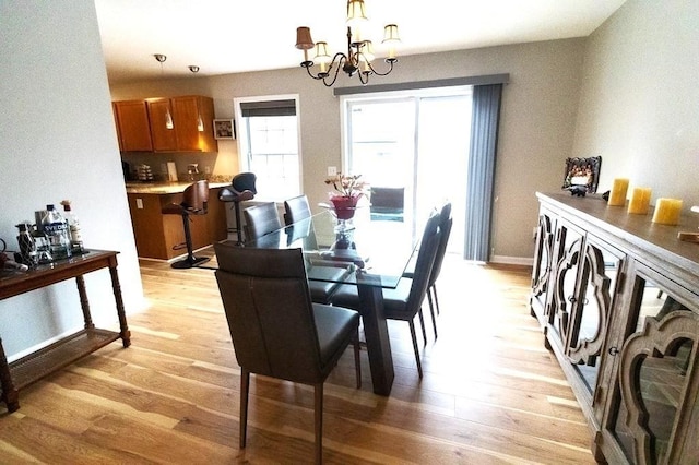 167 Orient St, Worcester, MA 01604 - dining area featuring light wood-style floors, a chandelier, and healthy amount of natural light