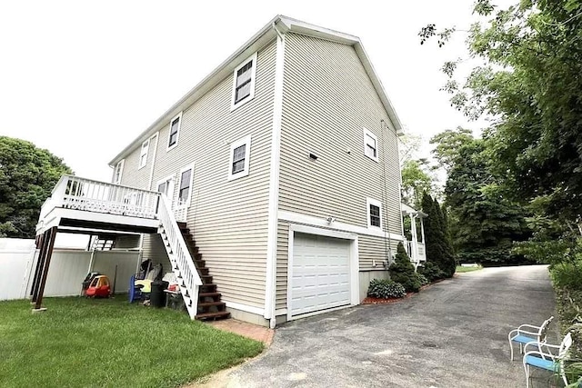 167 Orient St, Worcester, MA 01604 - view of property exterior featuring stairs, a wooden deck, a garage, driveway, and a yard