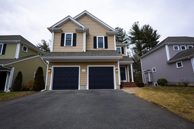 view of front of home featuring aphalt driveway, roof with shingles, and an attached garage