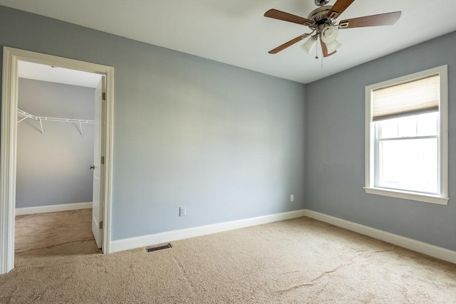 unfurnished bedroom featuring a closet, carpet, visible vents, and baseboards