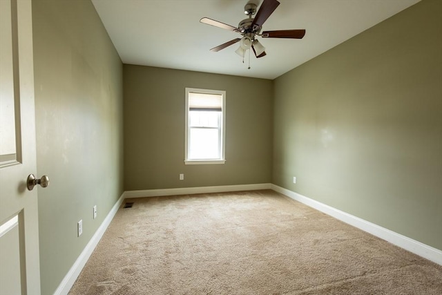 unfurnished room with ceiling fan, carpet floors, and baseboards