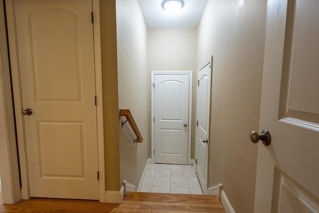 interior space featuring baseboards and light tile patterned floors