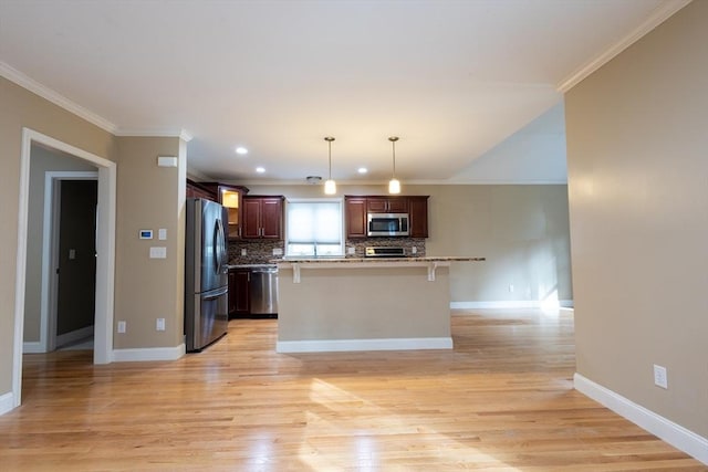 kitchen with stainless steel appliances, crown molding, backsplash, and light wood finished floors