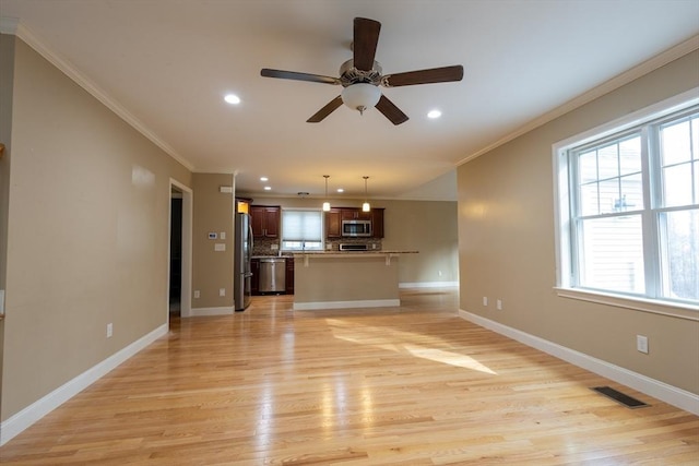 unfurnished living room featuring baseboards, visible vents, and crown molding