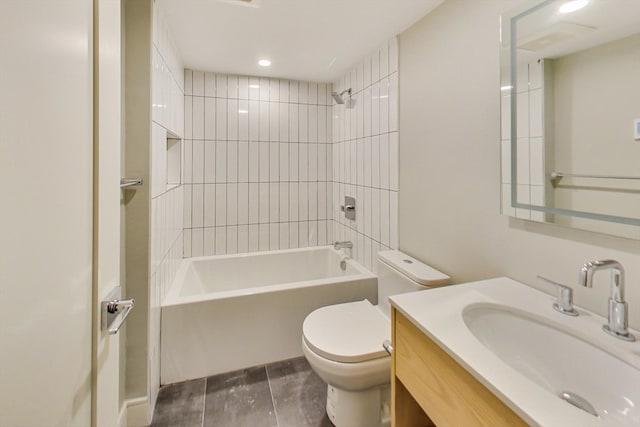 full bathroom featuring tile patterned floors, tiled shower / bath combo, vanity, and toilet