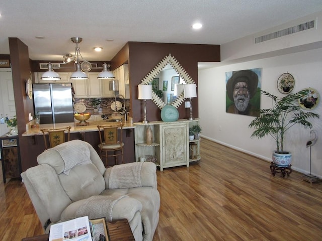 50 S Common St Unit 311, Lynn, MA 01902 - living room with wood finished floors, baseboards, and recessed lighting