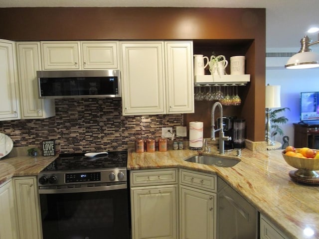 50 S Common St Unit 311, Lynn, MA 01902 - kitchen featuring stainless steel appliances, a sink, backsplash, and light stone countertops