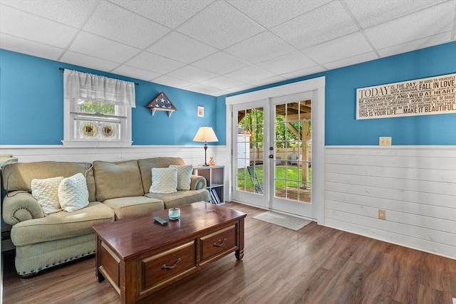 39 Taylor St Unit 39, Haverhill, MA 01830 - living room with a paneled ceiling, wainscoting, french doors, wood finished floors, and wood walls