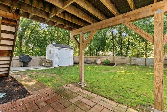 39 Taylor St Unit 39, Haverhill, MA 01830 - fenced backyard with a storage unit, a patio area, and area for grilling