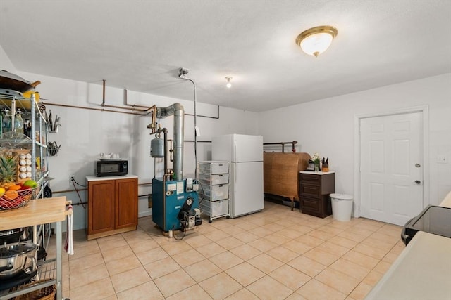 6 Gavin Cir, Stoneham, MA 02180 - finished below grade area with freestanding refrigerator, light tile patterned floors, and a heating unit