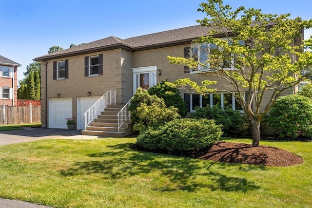 6 Gavin Cir, Stoneham, MA 02180 - view of front facade with concrete driveway, an attached garage, and brick siding
