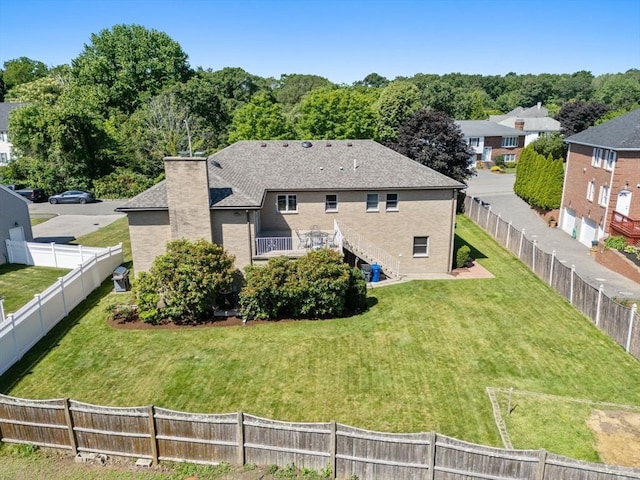 6 Gavin Cir, Stoneham, MA 02180 - rear view of property featuring a fenced backyard, a chimney, stairs, and roof with shingles