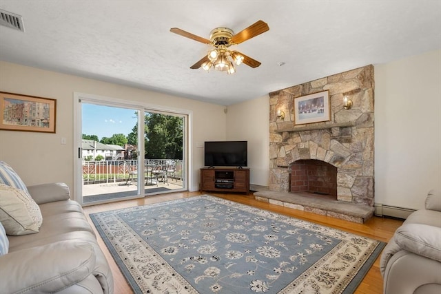 6 Gavin Cir, Stoneham, MA 02180 - living area featuring a ceiling fan, a baseboard radiator, wood finished floors, and a fireplace