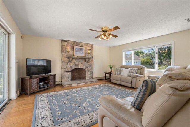 6 Gavin Cir, Stoneham, MA 02180 - living room featuring healthy amount of natural light, wood finished floors, ceiling fan, and a baseboard radiator