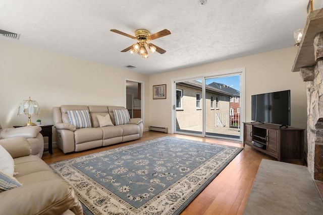 6 Gavin Cir, Stoneham, MA 02180 - living room with baseboard heating, a ceiling fan, and wood finished floors