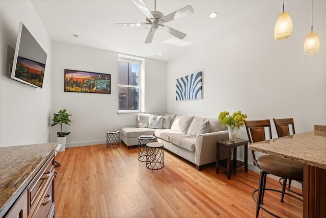 living room with recessed lighting, baseboards, ceiling fan, and light wood finished floors