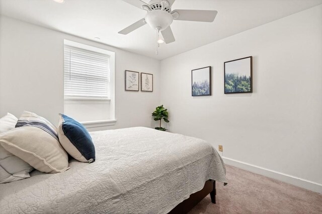 carpeted bedroom featuring baseboards and ceiling fan