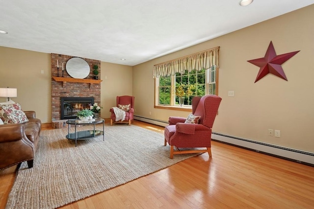 8 Adams Rd, Grafton, MA 01519 - living area with a baseboard heating unit, wood finished floors, a fireplace, and recessed lighting