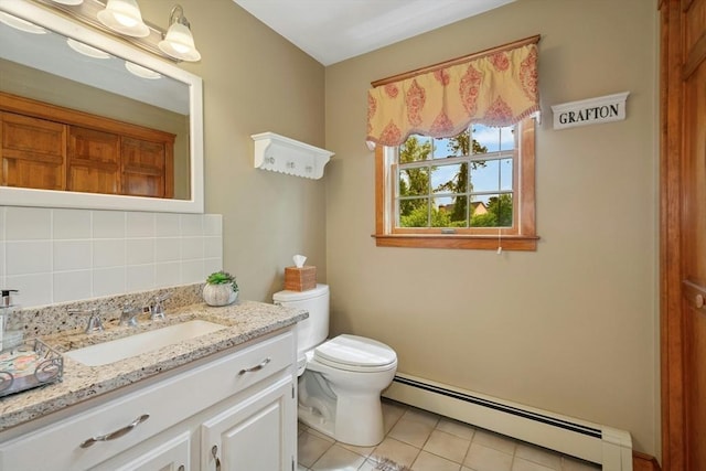 8 Adams Rd, Grafton, MA 01519 - bathroom with a baseboard heating unit, tile patterned floors, vanity, toilet, and backsplash