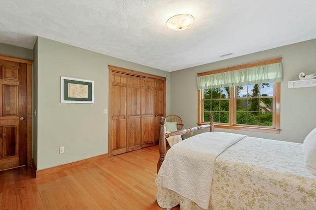 8 Adams Rd, Grafton, MA 01519 - bedroom with light wood finished floors, baseboards, and a closet