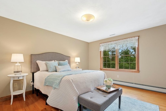 8 Adams Rd, Grafton, MA 01519 - bedroom with wood finished floors, baseboard heating, and baseboards