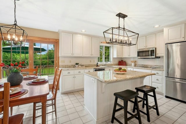 8 Adams Rd, Grafton, MA 01519 - kitchen featuring stainless steel appliances, a chandelier, light tile patterned floors, a kitchen island, and recessed lighting