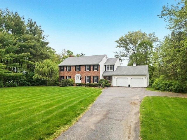 8 Adams Rd, Grafton, MA 01519 - colonial home with an attached garage, driveway, a front lawn, a chimney, and brick siding
