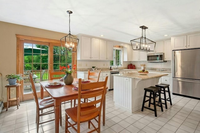 8 Adams Rd, Grafton, MA 01519 - kitchen featuring appliances with stainless steel finishes, a chandelier, a center island, decorative backsplash, and recessed lighting