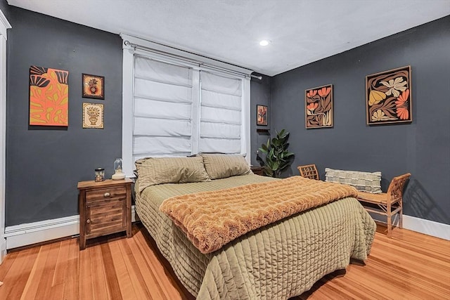 bedroom featuring baseboards, light wood-style floors, recessed lighting, and baseboard heating