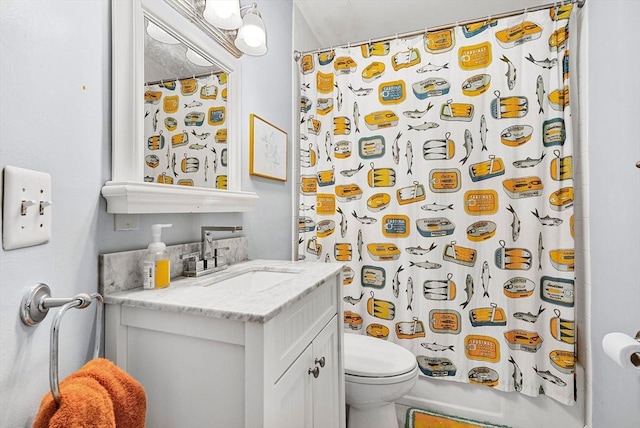 bathroom featuring toilet and vanity