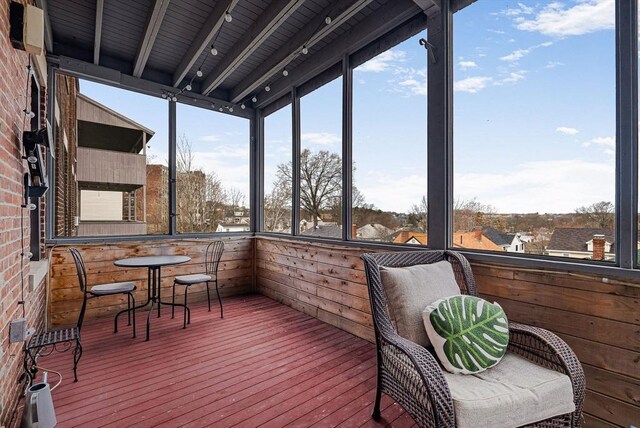 sunroom / solarium featuring track lighting