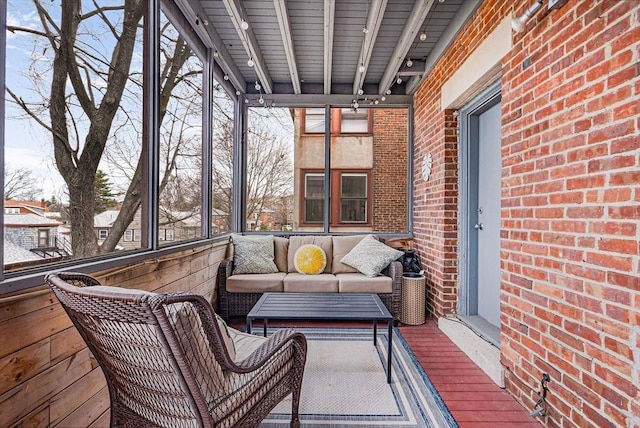 sunroom with an outdoor hangout area and rail lighting