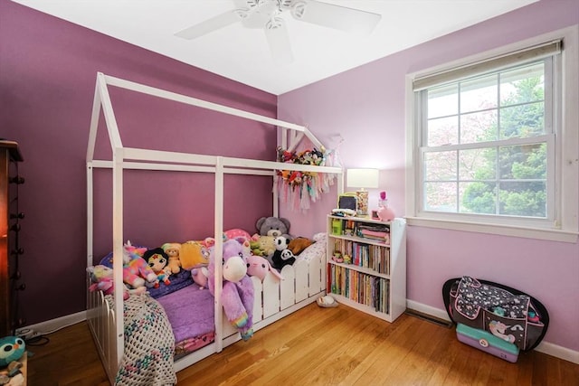 bedroom with baseboards, a ceiling fan, and wood finished floors