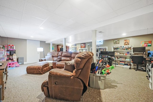 carpeted living area with a drop ceiling