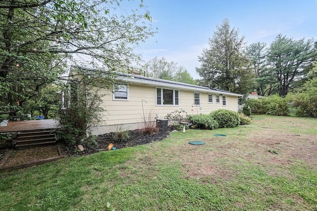exterior space featuring a yard and central air condition unit