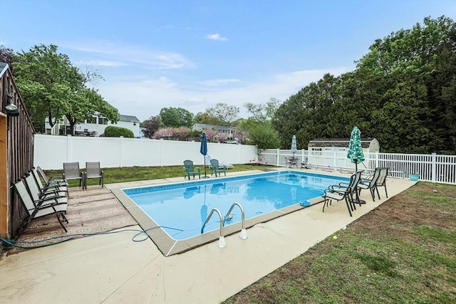view of swimming pool with a patio area, a fenced in pool, and a fenced backyard