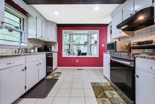 kitchen featuring under cabinet range hood, baseboards, light tile patterned flooring, tasteful backsplash, and appliances with stainless steel finishes