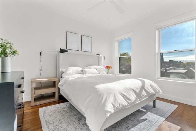 bedroom with baseboards, dark wood-style flooring, and ornamental molding