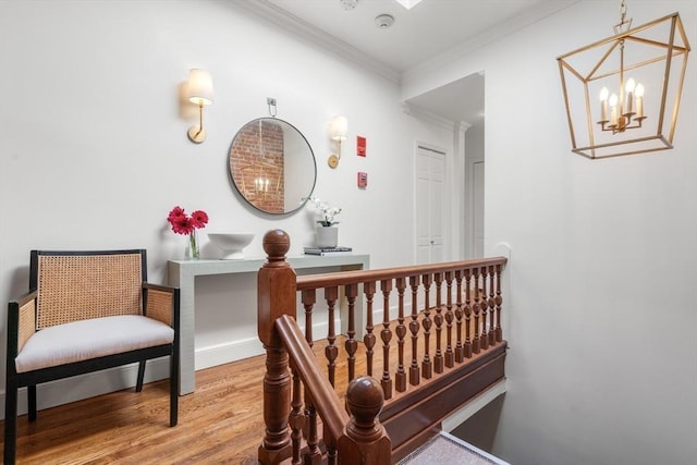 hallway with ornamental molding, baseboards, and wood finished floors