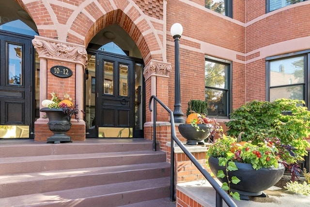 doorway to property with brick siding