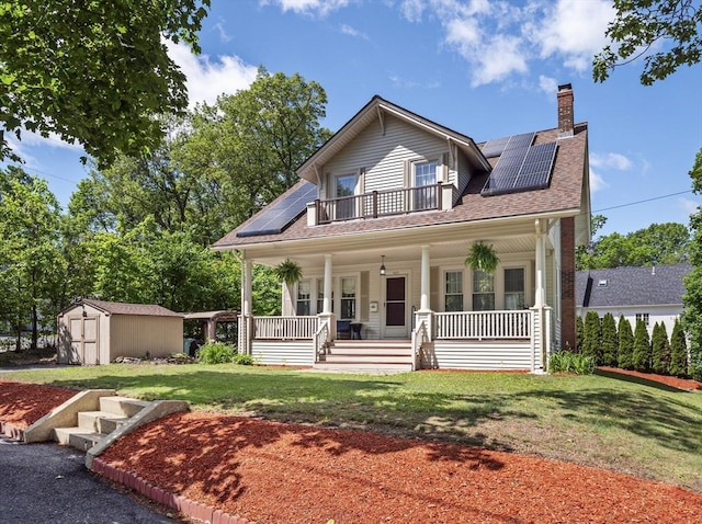 537 Milk St, Fitchburg, MA 01420 - view of front of property with covered porch, solar panels, a chimney, a front yard, and roof with shingles