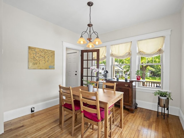 537 Milk St, Fitchburg, MA 01420 - dining area featuring baseboards, hardwood / wood-style flooring, and a chandelier