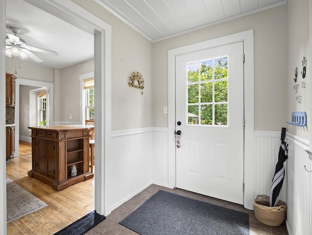 537 Milk St, Fitchburg, MA 01420 - doorway with wainscoting, crown molding, a ceiling fan, and wood finished floors